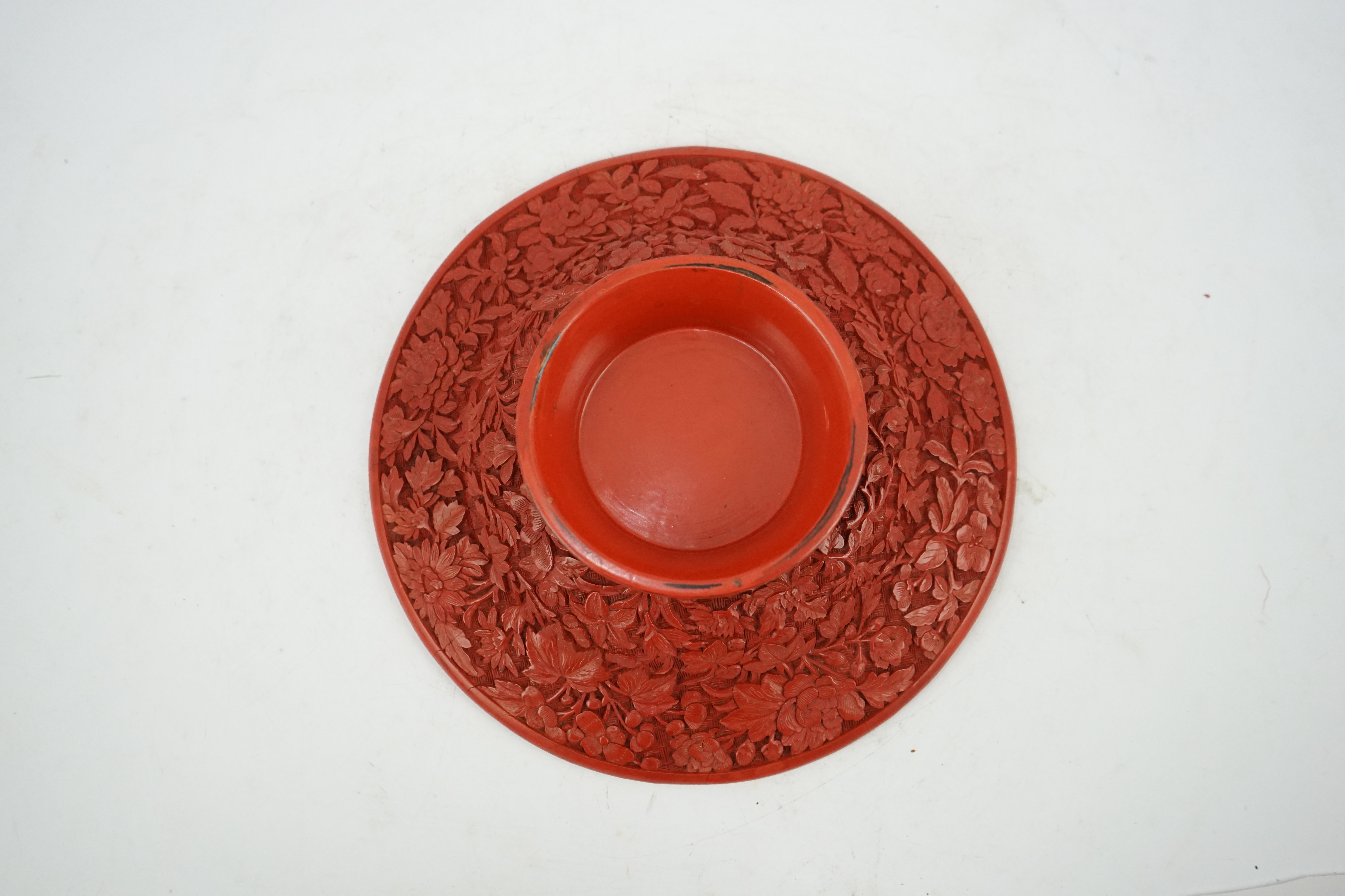 An unusual Chinese cinnabar lacquer ‘thousand flower’ footed dish, 18th/19th century